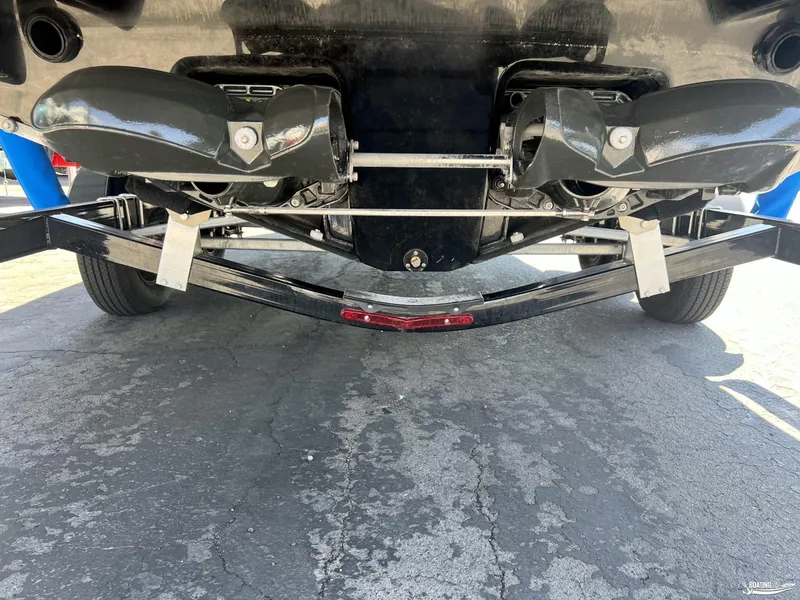 Slide: The Image of 2019 Chaparral Vortex 223 VRX boat underside showing dual exhaust system and trailer. - 7