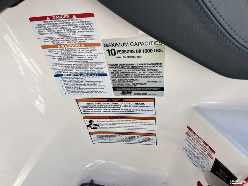Slide: The Image of Warning labels and capacity information on a 2019 Chaparral Vortex 223 VRX boat. - 9