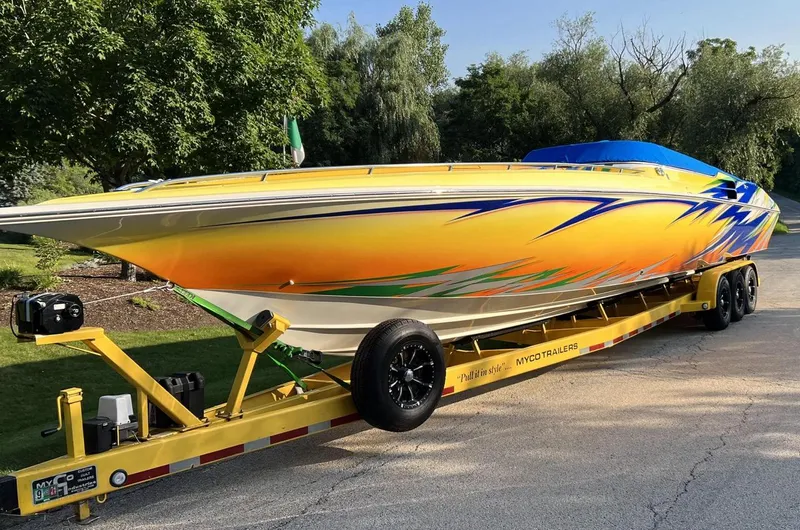 The Image of 2007 Fountain 42 Lightning speedboat on a yellow trailer, vibrant custom paint job. - 1