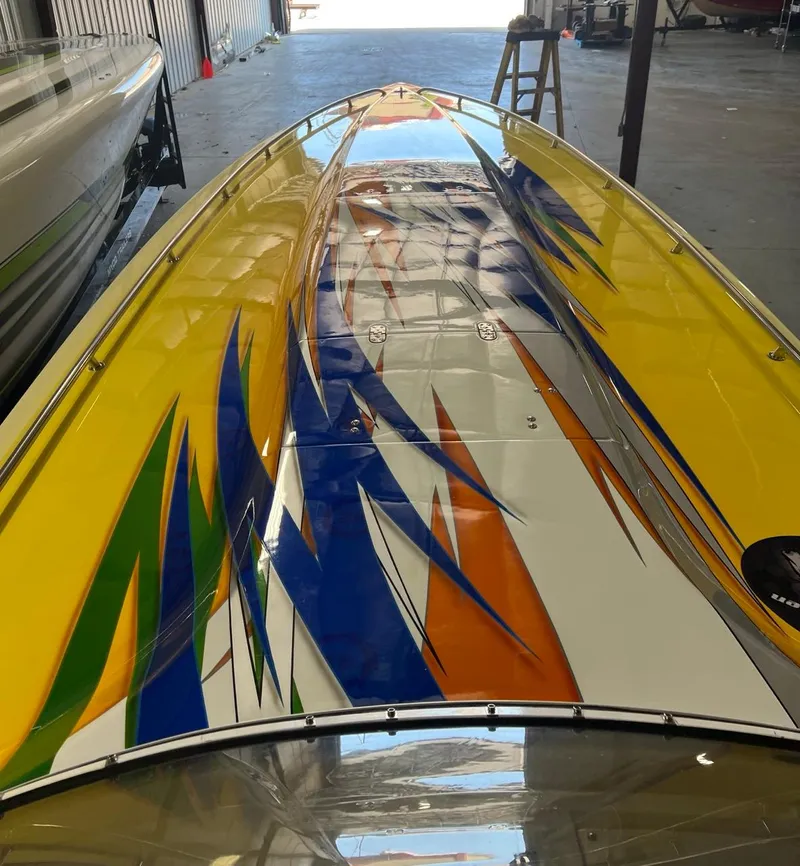Slide: The Image of 2007 Fountain 42 Lightning speedboat with vibrant yellow, blue, and orange graphics. - 16
