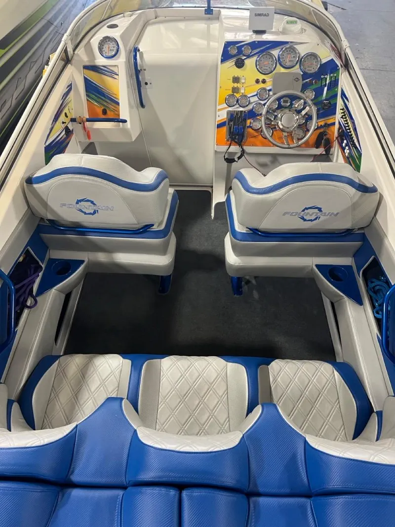 Slide: The Image of 2007 Fountain 42 Lightning boat interior with blue and white seating and colorful dashboard. - 17