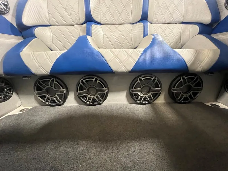 Slide: The Image of 2007 Fountain 42 Lightning boat interior with blue and white seating and multiple speakers. - 19