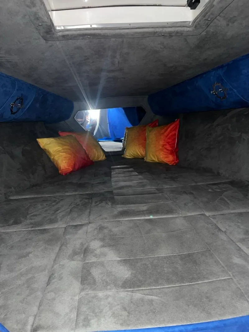 Slide: The Image of Interior cabin of a 2007 Fountain 42 Lightning boat with colorful pillows. - 27