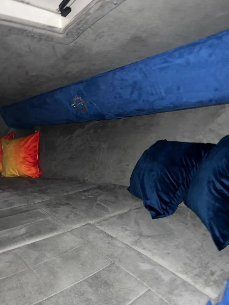 Slide: The Image of Interior cabin of a 2007 Fountain 42 Lightning boat with blue and orange pillows. - 28