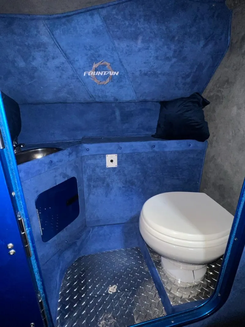 Slide: The Image of 2007 Fountain 42 Lightning boat interior bathroom with blue upholstery and diamond plate flooring. - 31