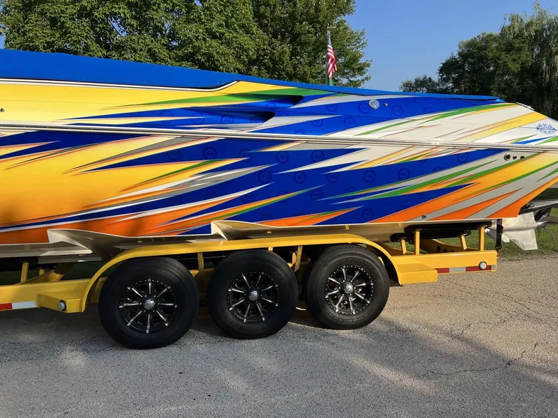 Slide: The Image of 2007 Fountain 42 Lightning boat with vibrant custom paint on a yellow trailer. - 4