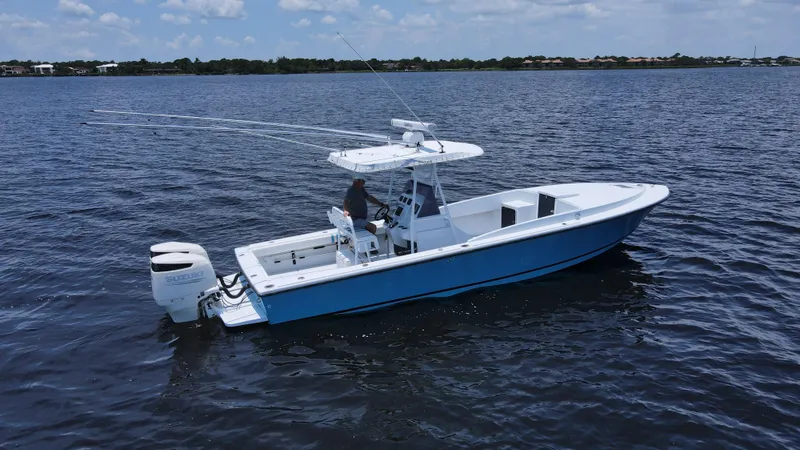 Slide: The Image of 1990 Intrepid 321 Cuddy boat cruising on open water. - 0