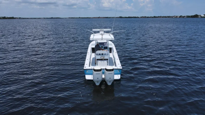 Slide: The Image of 1990 Intrepid 321 Cuddy boat on open water. - 1