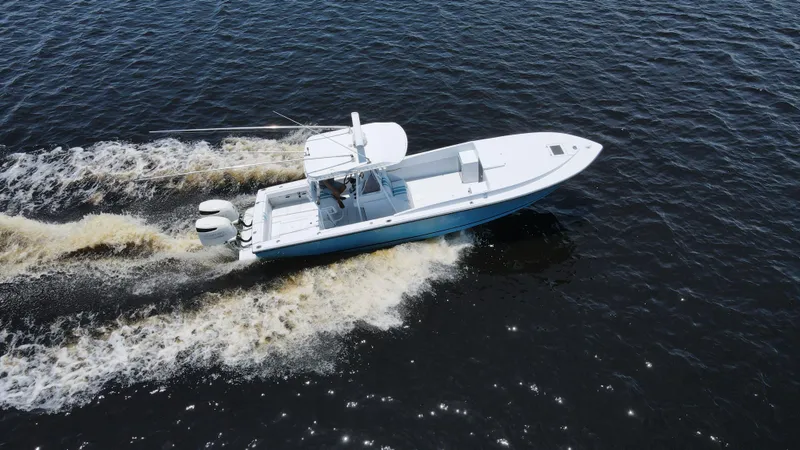 Slide: The Image of Intrepid 321 Cuddy 1990 boat cruising on open water, aerial view. - 13