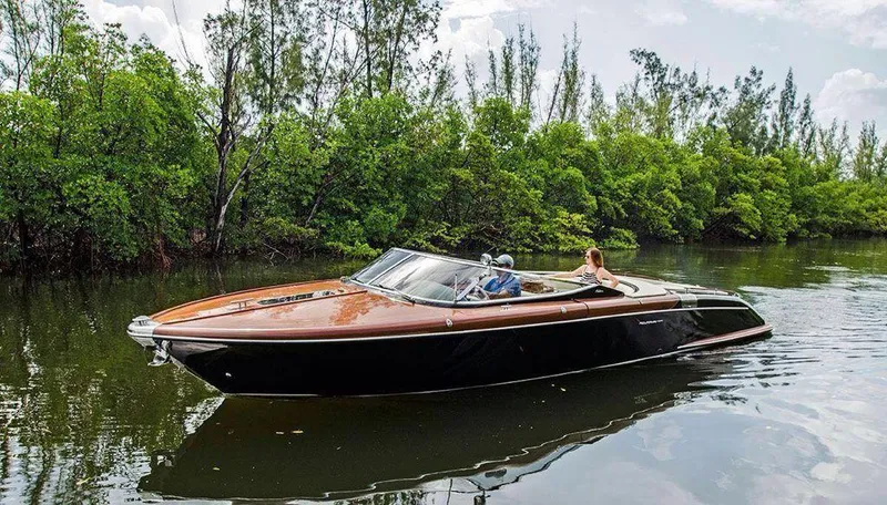 The Image of 2010 Riva Aquariva 33 luxury boat on a serene waterway. - 0