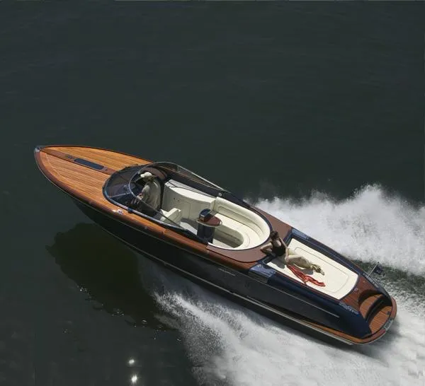 Slide: The Image of 2010 Riva Aquariva Super 33 luxury speedboat cruising on water. - 2