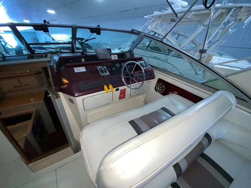 Slide: The Image of 1990 Sea Ray Sundancer boat cockpit with steering wheel and control panel. - 11