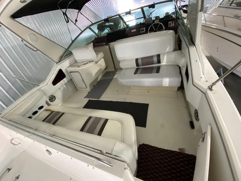 Slide: The Image of 1990 Sea Ray Sundancer boat interior with white seating and dashboard. - 3