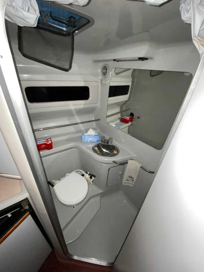 Slide: The Image of 1990 Sea Ray Sundancer boat bathroom with sink and toilet. - 4