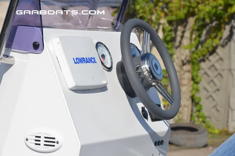 Slide: The Image of Close-up of Gala A450 boat dashboard with Lowrance device, steering wheel, and gauges. - 6