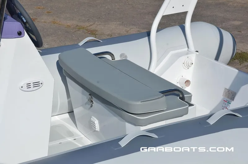 Slide: The Image of 2025 Gala A450 boat interior with gray seating and storage compartment. - 8