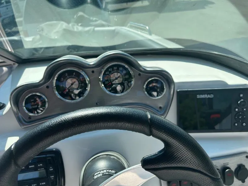 Slide: The Image of Dashboard of 2022 NauticStar 203DC Sport Deck boat with gauges and Simrad display. - 6