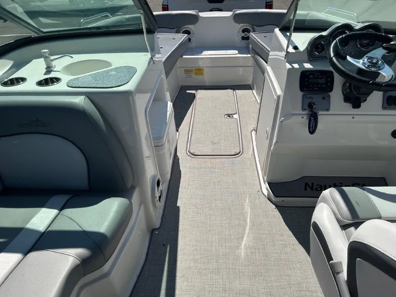Slide: The Image of 2022 NauticStar 203DC Sport Deck interior with seating and steering console. - 4