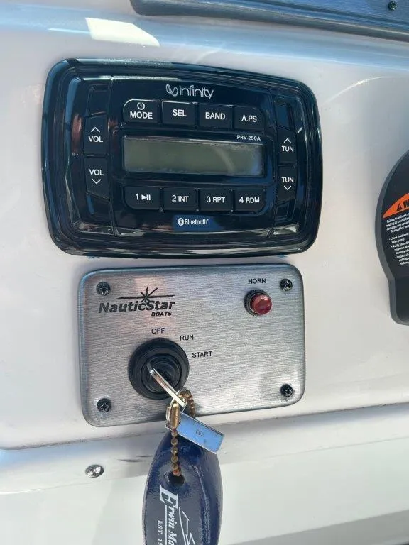 Slide: The Image of Control panel of 2022 NauticStar 203DC Sport Deck boat with Infinity stereo system. - 7