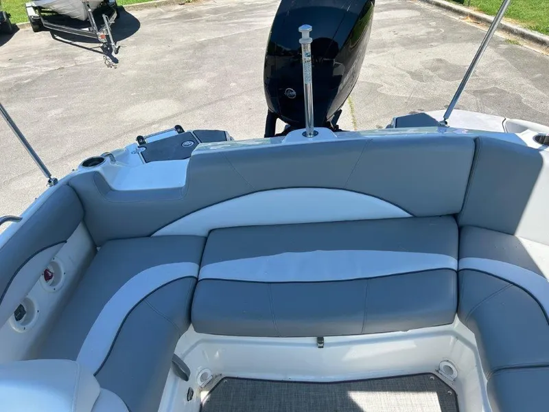Slide: The Image of 2022 NauticStar 203DC Sport Deck boat with gray and white seating. - 8
