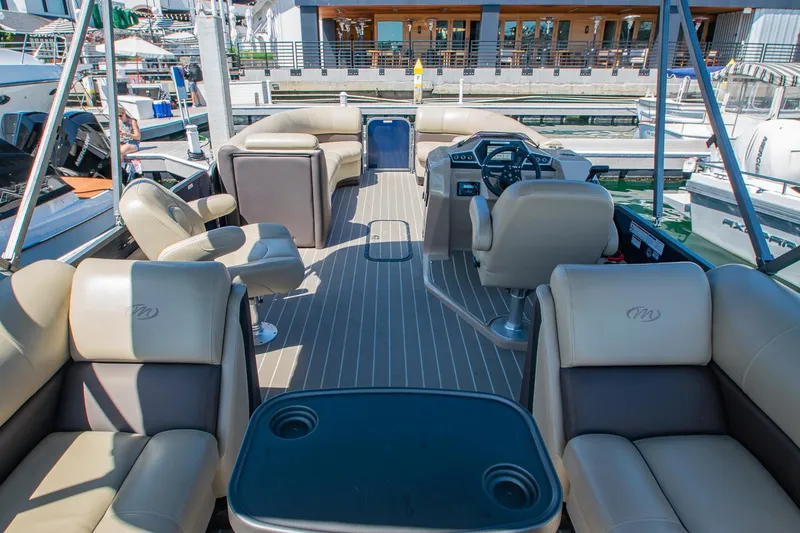 Slide: The Image of 2021 Manitou Oasis SHP pontoon boat interior with luxurious seating and modern helm. - 46