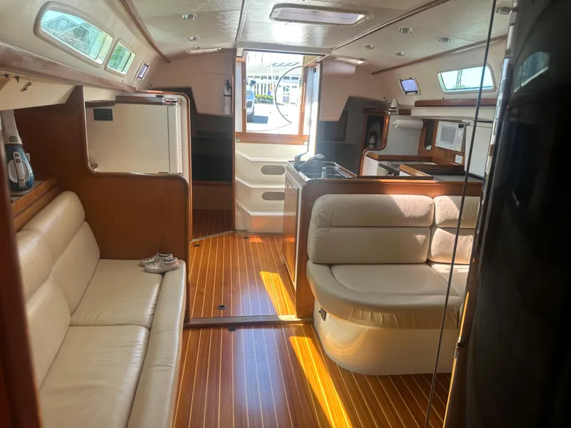 Slide: The Image of Interior of a 2001 Farr Concordia with elegant wood flooring and comfortable seating. - 12