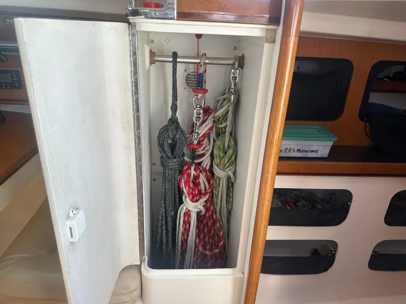 Slide: The Image of A cabinet inside a boat containing several ropes and lines. - 15