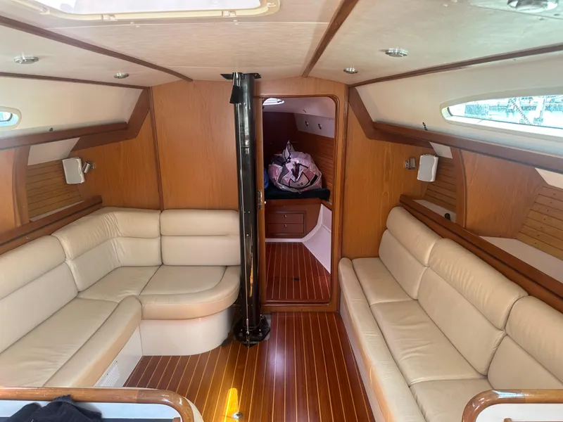 Slide: The Image of Interior of a 2001 Farr Concordia with elegant wood accents and beige upholstered seating. - 8