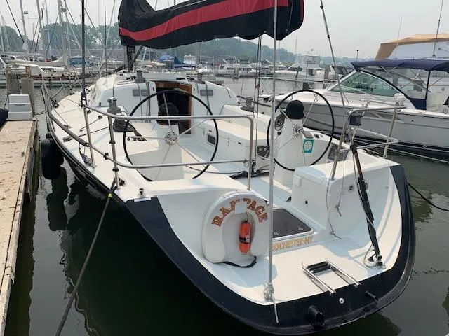 Slide: The Image of 2001 Farr Concordia sailboat docked, featuring dual steering wheels and a lifebuoy. - 36