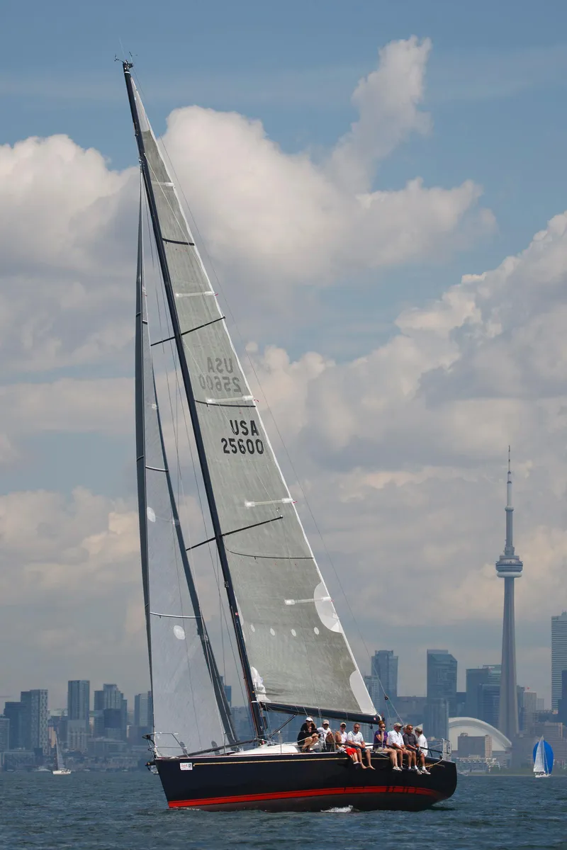 Slide: The Image of A 2001 Farr Concordia sailing near a city with a prominent tower. - 27