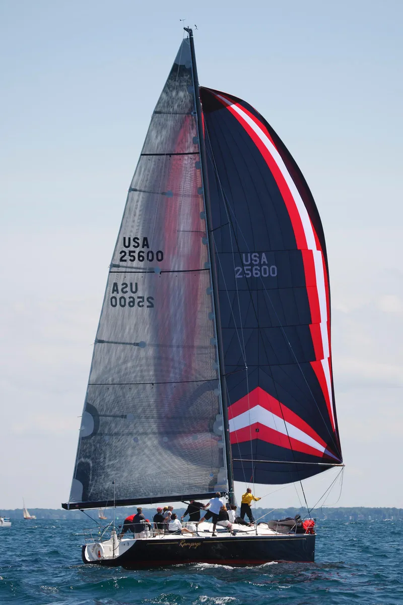 Slide: The Image of A 2001 Farr Concordia sailing with a colorful spinnaker on open water. - 26