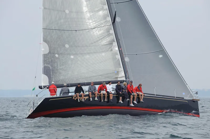 Slide: The Image of Sailboat with crew on the water. - 25