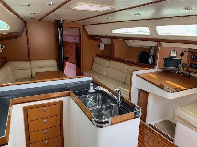 Slide: The Image of Interior of a 2001 Farr Concordia with elegant wood paneling and modern amenities. - 33