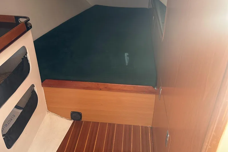 Slide: The Image of Interior of a 2001 Farr Concordia with wooden flooring and sleeping area. - 39