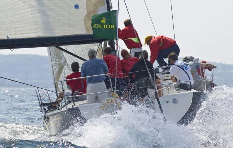Slide: The Image of Sailboat with crew on the water, cutting through waves. - 24