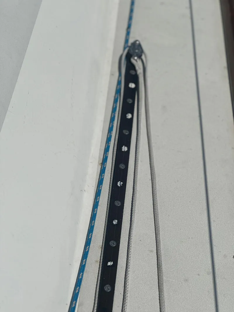 Slide: The Image of Close-up of a sailboat with rope and track on the deck. - 21