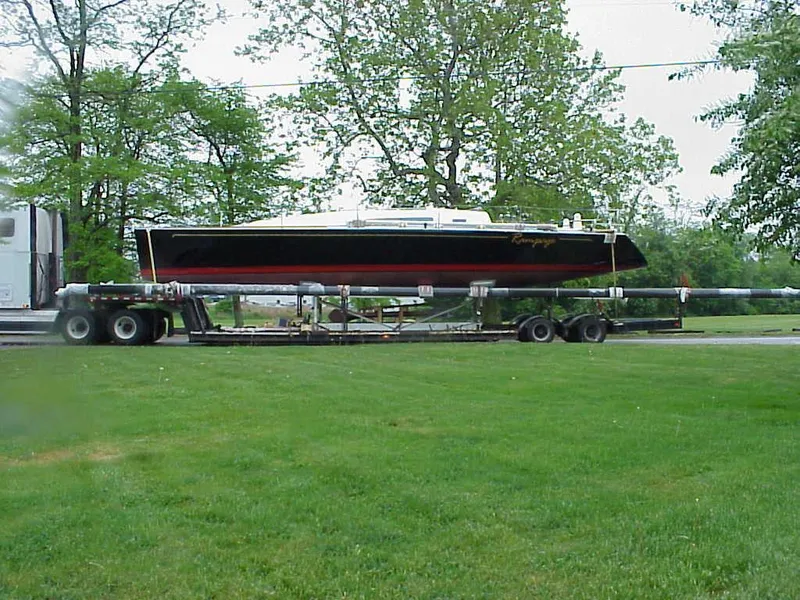 Slide: The Image of A 2001 Farr Concordia on a trailer, surrounded by trees and grass. - 30