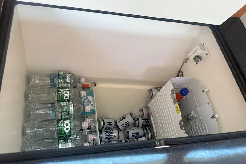 Slide: The Image of A refrigerator with water bottles and beverage cans inside. - 38
