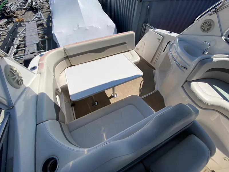 Slide: The Image of 2005 Chaparral 290 Signature boat interior with seating and table setup. - 13