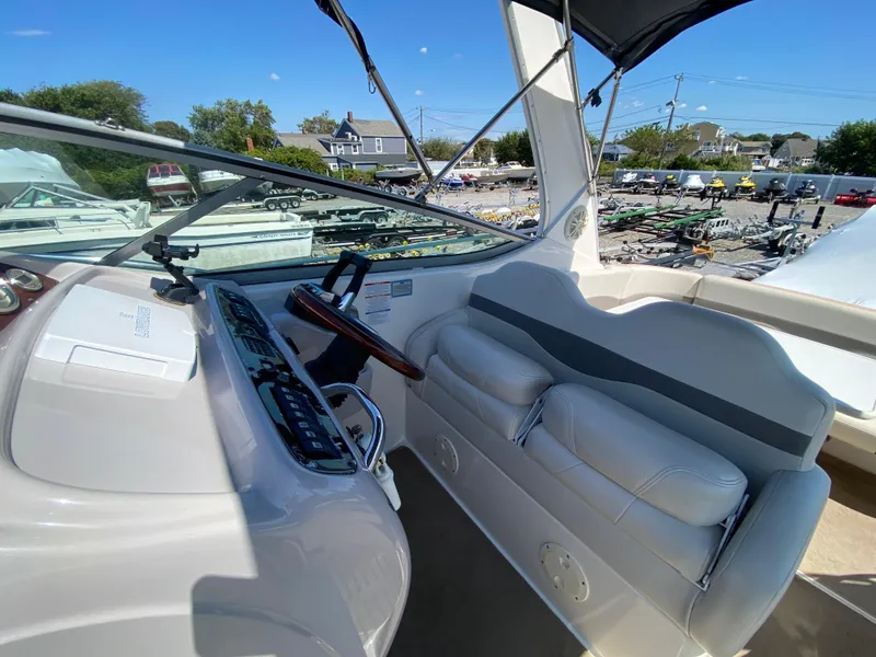 Slide: The Image of 2005 Chaparral 290 Signature boat cockpit with steering wheel and seating. - 17