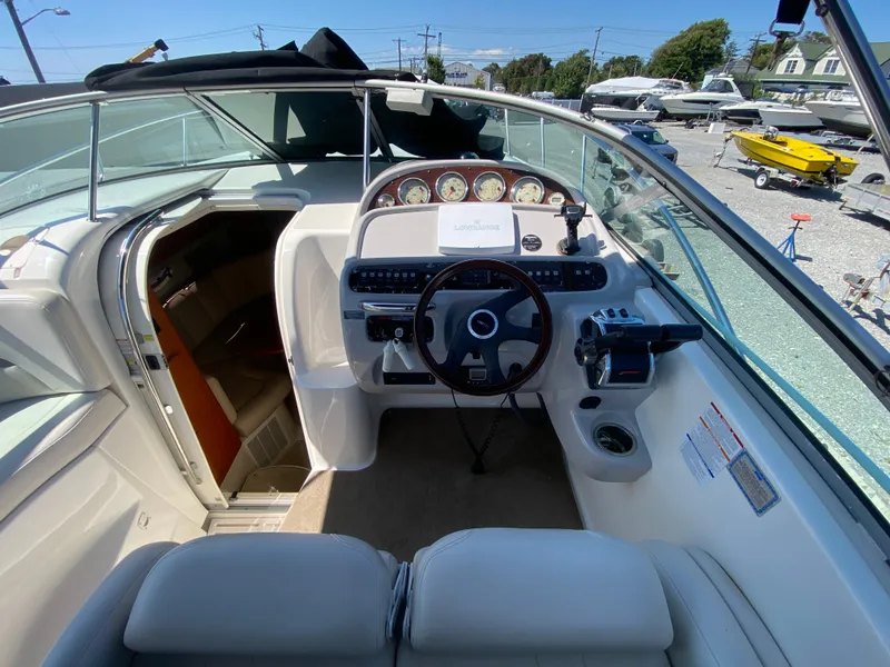 Slide: The Image of 2005 Chaparral 290 Signature boat cockpit with steering wheel and dashboard controls. - 19