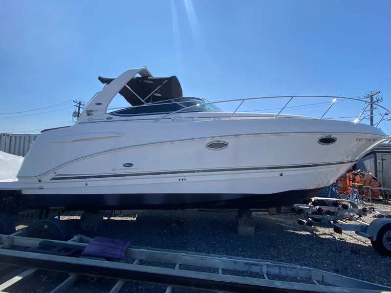 Slide: The Image of 2005 Chaparral 290 Signature boat on dry dock under clear blue sky. - 2