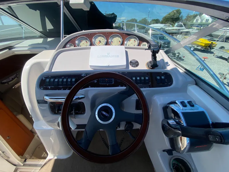 Slide: The Image of 2005 Chaparral 290 Signature boat dashboard with steering wheel and control panel. - 20