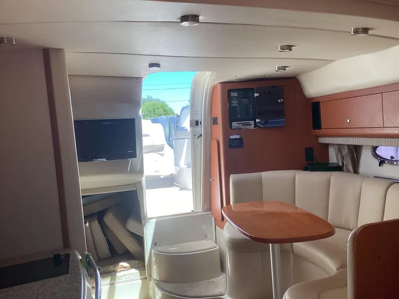 Slide: The Image of Interior of 2005 Chaparral 290 Signature boat with seating area and TV. - 31