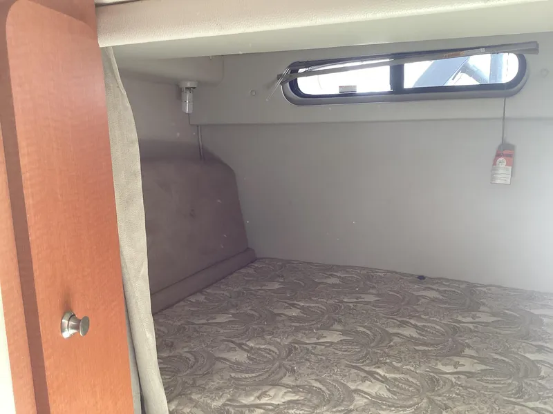 Slide: The Image of 2005 Chaparral 290 Signature cabin interior with bed and window. - 33