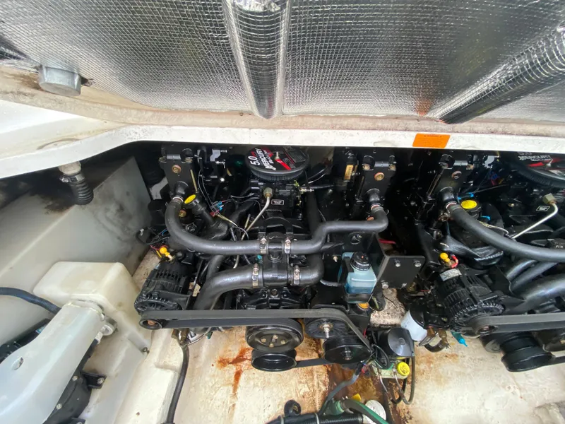 Slide: The Image of Engine compartment of a 2005 Chaparral 290 Signature boat, showcasing dual engines. - 42