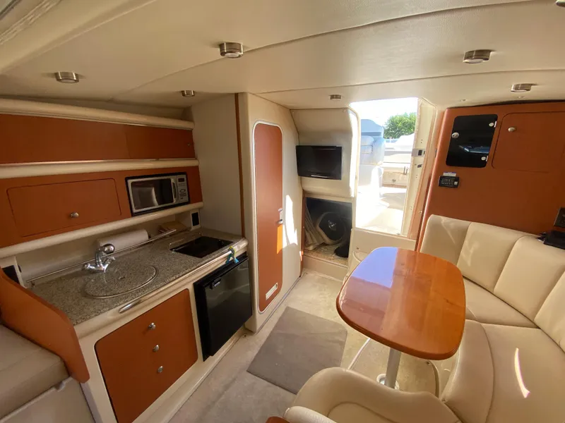 Slide: The Image of Interior of 2005 Chaparral 290 Signature boat with kitchenette and seating area. - 30