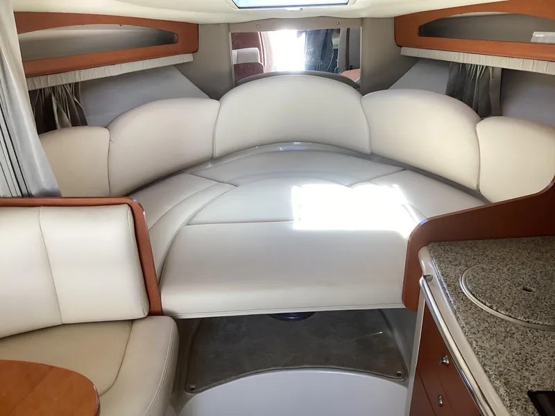 Slide: The Image of Interior of 2005 Chaparral 290 Signature boat with white leather seating and kitchenette. - 26