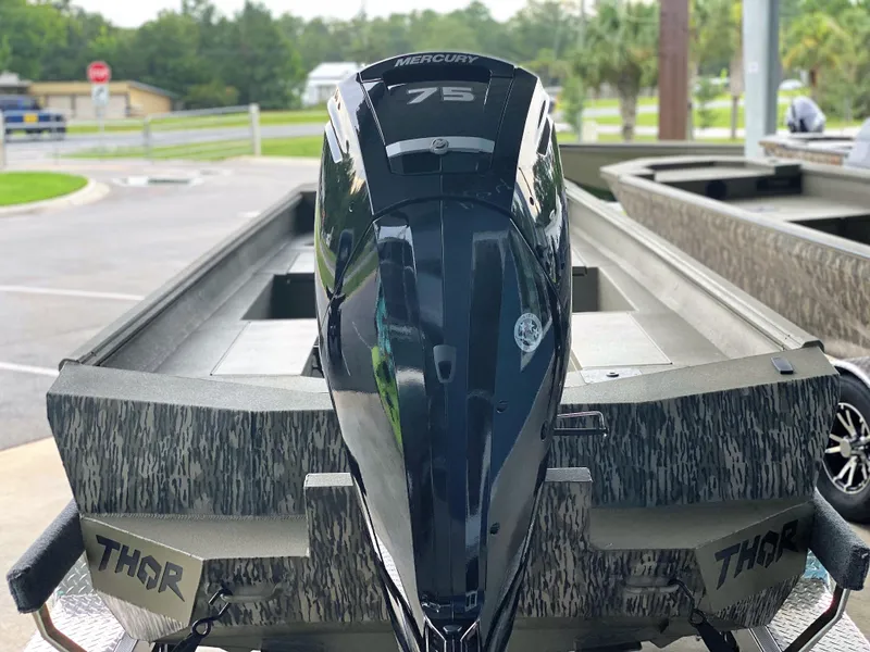 Slide: The Image of 2023 Thor 1860 boat with Mercury 75 engine, parked outdoors. - 4