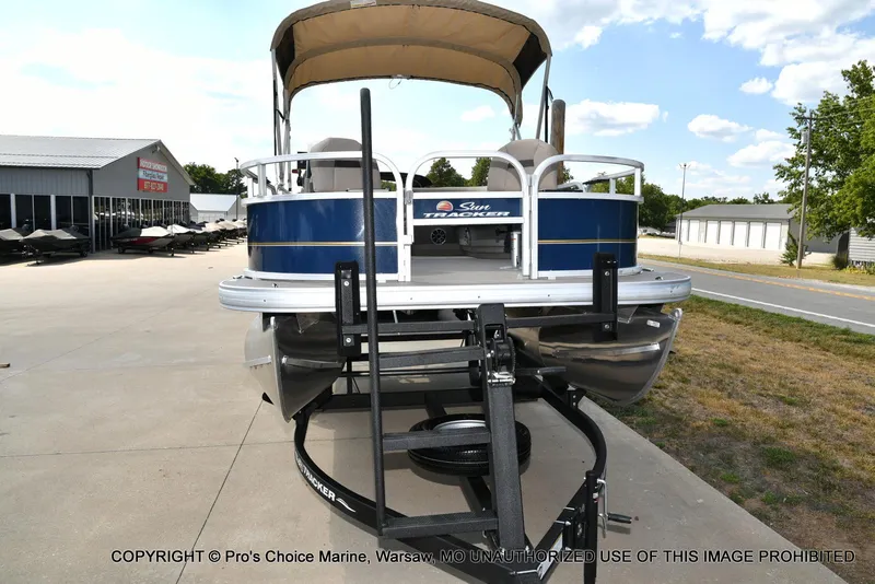 Slide: The Image of 2025 Sun Tracker Bass Buggy 16 XL Select pontoon boat on trailer at dealership. - 15